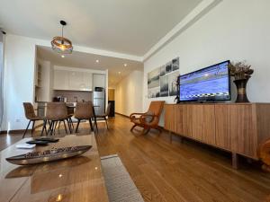 a living room with a large flat screen tv at BW Arcadia deluxe apartments in Sajmište
