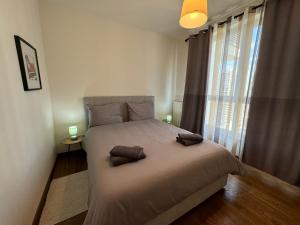 a bedroom with a large bed with two pillows on it at BW Arcadia deluxe apartments in Sajmište