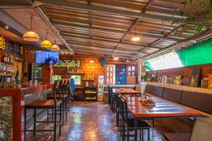 a restaurant with tables and chairs and a bar at Happy House Backpackers in Pai