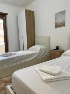a bedroom with two beds and a mirror at Happy house in Civitavecchia