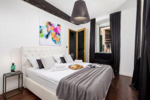 Un dormitorio con una cama blanca y una mesa. en Apartment J'adore by Rent Istria, en Rijeka