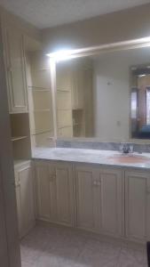 an empty kitchen with a sink and a mirror at Apartamento en Chicó Norte in Bogotá