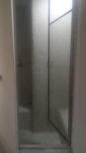 a glass shower door with a mirror in a bathroom at Apartamento en Chicó Norte in Bogotá
