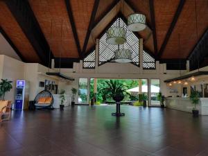 a lobby with a large room with a table and windows at K106 Alta Vista De Boracay in Boracay