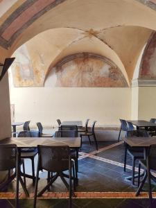 an empty room with tables and chairs in a building at La Maddalena Apartment in Bordighera