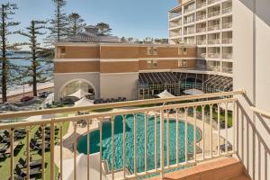 a view of the pool from the balcony of a hotel at Crowne Plaza Terrigal Pacific by IHG in Terrigal