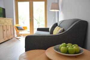 a bowl of green apples on a table in a living room at Milk Parlour in Spexhall