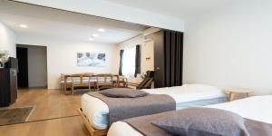 a hotel room with two beds and a table at UCHI Susukino 5.7 in Sapporo