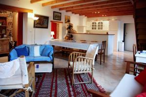a kitchen and living room with a table and chairs at La Villa Flore in Saint-Jouin-Bruneval