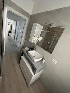 a bathroom with a sink and a toilet at House of Flowers in Spinea