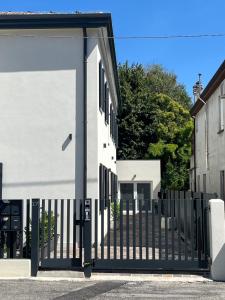 a black gate in front of a white building at House of Flowers in Spinea