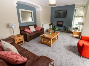 a living room with a couch and a table at Morva in New Quay