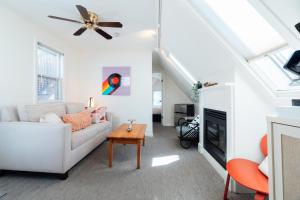 a living room with a white couch and a ceiling fan at Mercury Hotel Provincetown in Provincetown