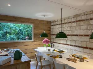 a dining room with a white table and green lights at Domaine de Fresnoy in Loison-sur-Créquoise