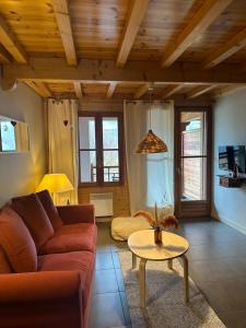 una sala de estar con un sofá y una mesa en Les chalets d'Arrens, en Arrens-Marsous