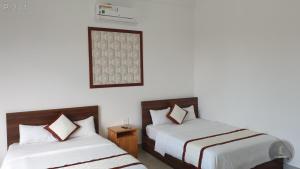 Postel nebo postele na pokoji v ubytování Vy An Hotel