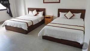 Postel nebo postele na pokoji v ubytování Vy An Hotel