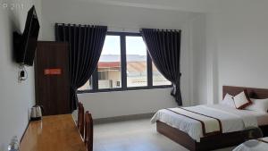 Postel nebo postele na pokoji v ubytování Vy An Hotel