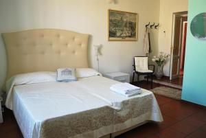 a bedroom with a large bed with a white bedspread at San Peter's Corner in Rome