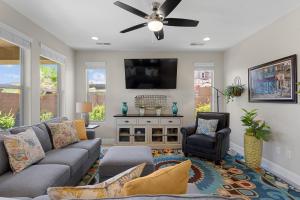 a living room with a couch and a tv at House It Going home in Washington +30 photos
