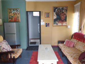 a living room with two couches and a table at Bedford Way cottages in Bedford
