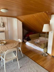 a bedroom with a bed and a table with a lamp at Kostis Central Loft in Metsovo