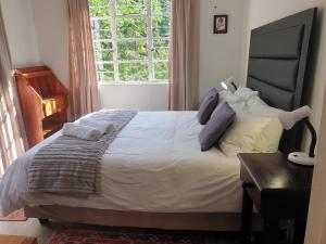 a bedroom with a large bed and a window at Bedford Way cottages in Bedford