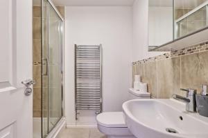 a bathroom with a sink and a toilet and a shower at ESSEX Basildon 4 bedroom house 2 half bath in Basildon +36 photos