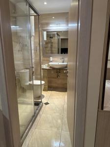 a bathroom with a toilet and a sink and a shower at Argisht STUDIO 602 in Golden Sands +7 photos