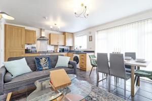 a living room and kitchen with a couch and a table at ESSEX Basildon 4 bedroom house 2 half bath in Basildon