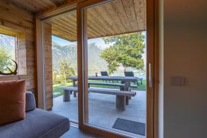 a glass door leading to a patio with a picnic table at El Rocol in Ledro