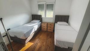 a room with two beds and a window at Sea Level in Kotor