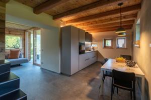 a kitchen and living room with a table and chairs at El Rocol in Ledro +19 photos