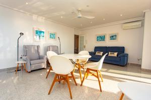 a living room with a table and chairs and a couch at Cullera Horizon Apartment in Cullera