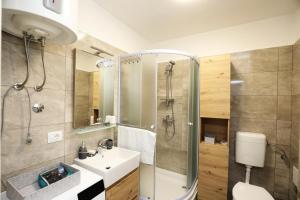 a bathroom with a sink and a shower at Apartment Ondina in Rijeka