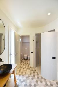 a bathroom with a sink and a toilet in a room at Ariti's Villas 2 - Naxos in Naxos Chora