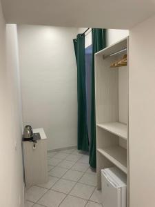 a room with a closet with a green shower curtain at Maison Museo in Naples