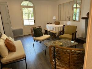 a living room with a couch and chairs and a table at Gite de St Venant in La Meignanne