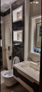 a bathroom with a sink and a toilet and a shower at Doctor's house in Lahore