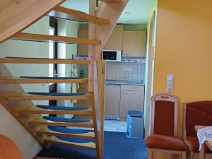 a wooden staircase in a room with a kitchen at Holiday Home Uckeritz - Seebad 1 in Ueckeritz