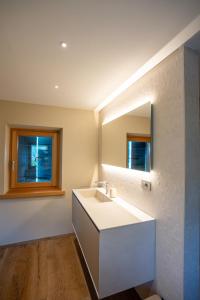 a bathroom with a white sink and a mirror at El Rocol in Ledro
