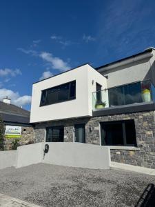 a white house with a stone facade at Rowing club house in Carrick on Shannon