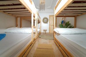 a room with two bunk beds and a table at Waves Hunter Surf House in Agadir