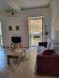 a living room with a couch and a coffee table at Mussomeli's Beautiful House in Mussomeli