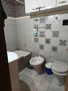 a bathroom with a toilet and a sink and a tub at Casita azul Bariloche in San Carlos de Bariloche