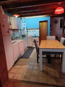 a kitchen with a table and a table and chairs at Casita azul Bariloche in San Carlos de Bariloche