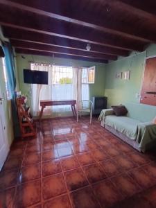 a living room with a couch and a table at Casita azul Bariloche in San Carlos de Bariloche