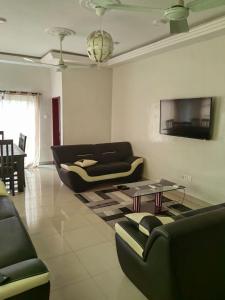 a living room with a couch and a table at Ouslane Appart-2 in Cotonou +14 photos