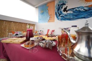 a table with pastries and other foods on it at Waves Hunter Surf House in Agadir