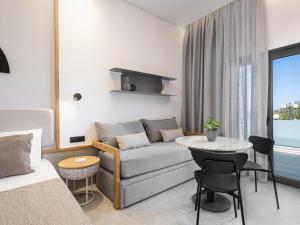 a living room with a couch and a table at Nontas suites in Kato Daratso